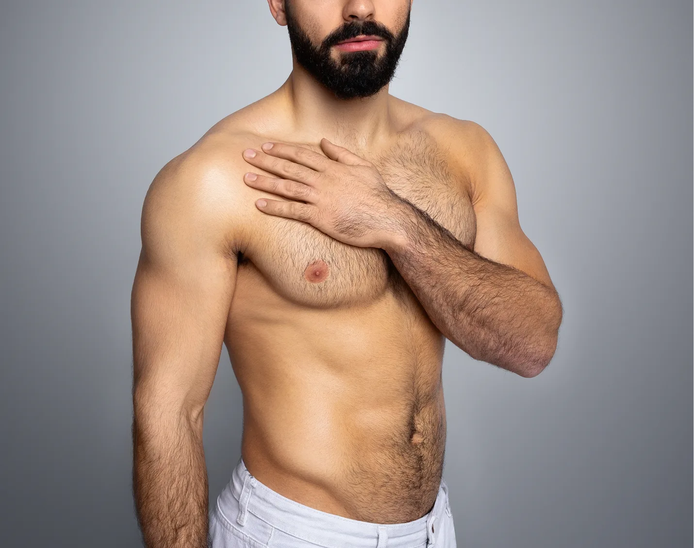 Bearded man touching his chest, demonstrating male body contouring concern
