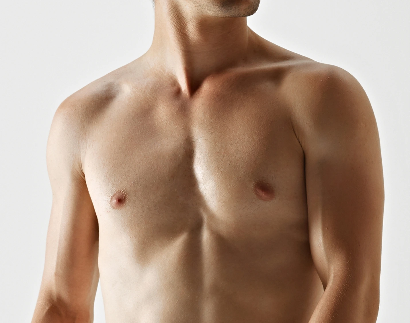 Shirtless man viewed from chest up, displaying a defined, sculpted chest