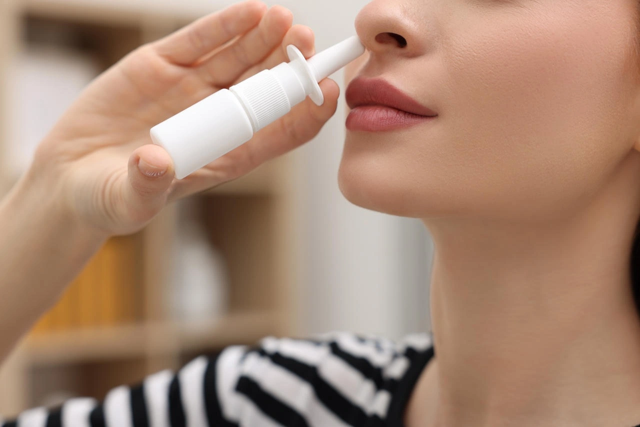 Adult patient using a nasal spray at home