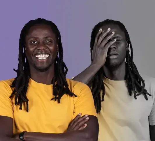 Two men against a purple background; one smiling in a yellow shirt, the other with hand to face appearing stressed