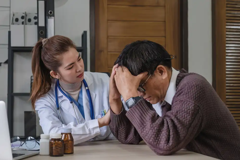Healthcare provider in white coat and stethoscope listening to patient discussing depression symptoms during consultation