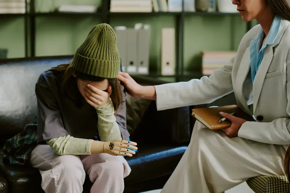 Psychiatric nurse practitioner comforting a distressed patient during a mental health consultation