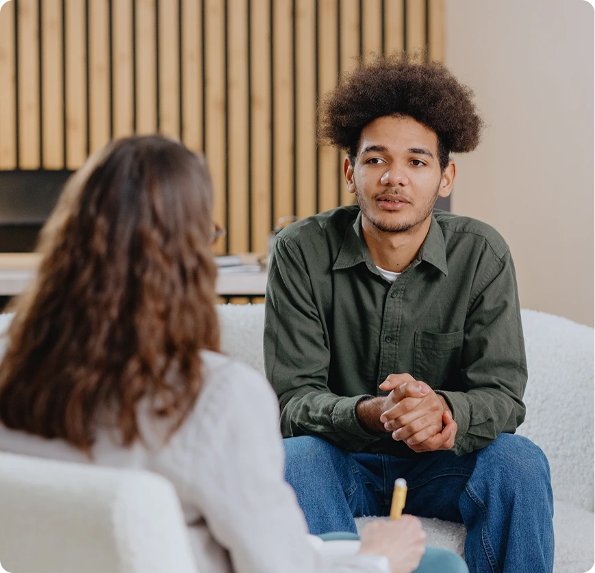 Patient in conversation with a clinician during a psychiatric consultation at Reliant Family Psychiatry
