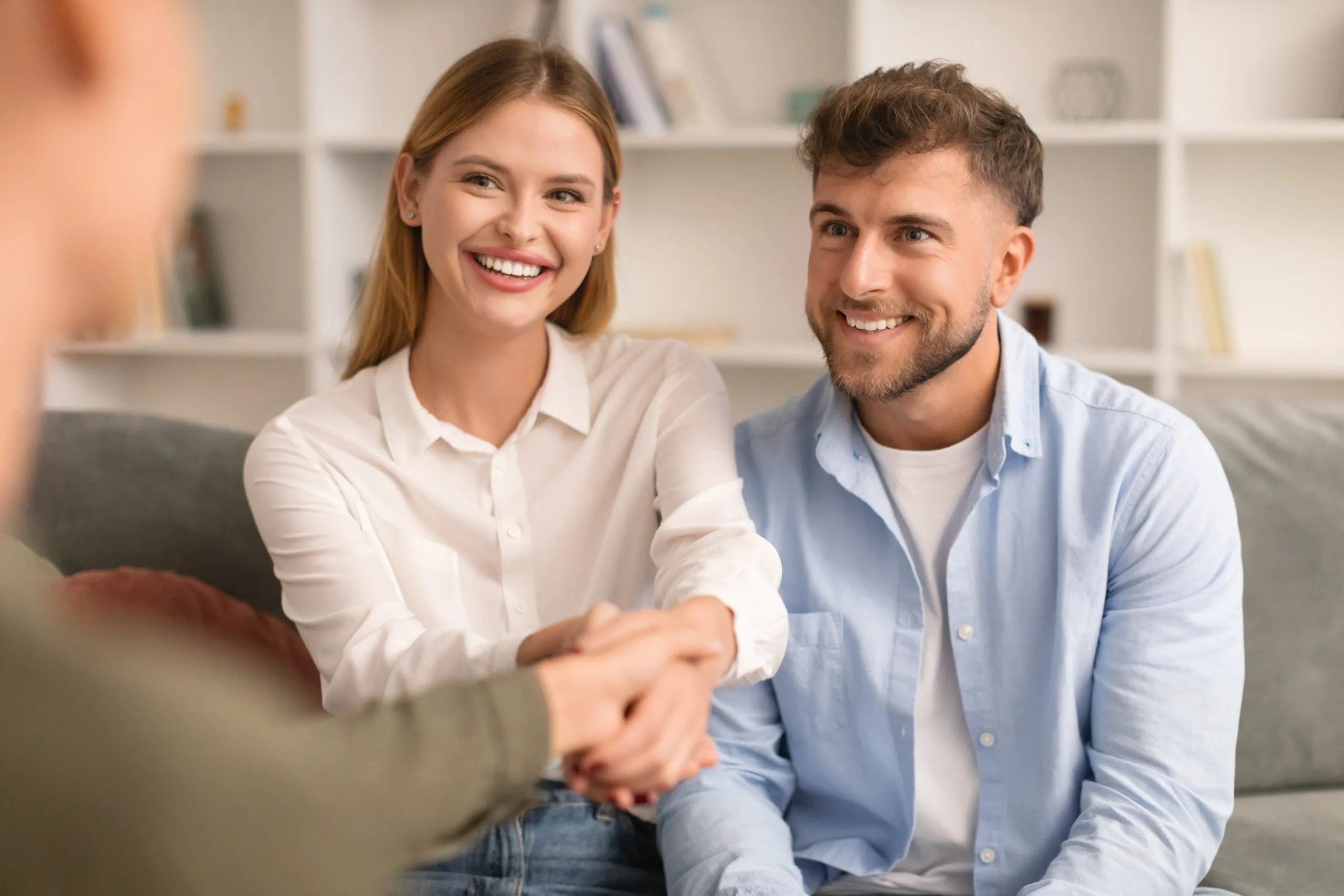 Couple smiling during a counseling session with a therapist