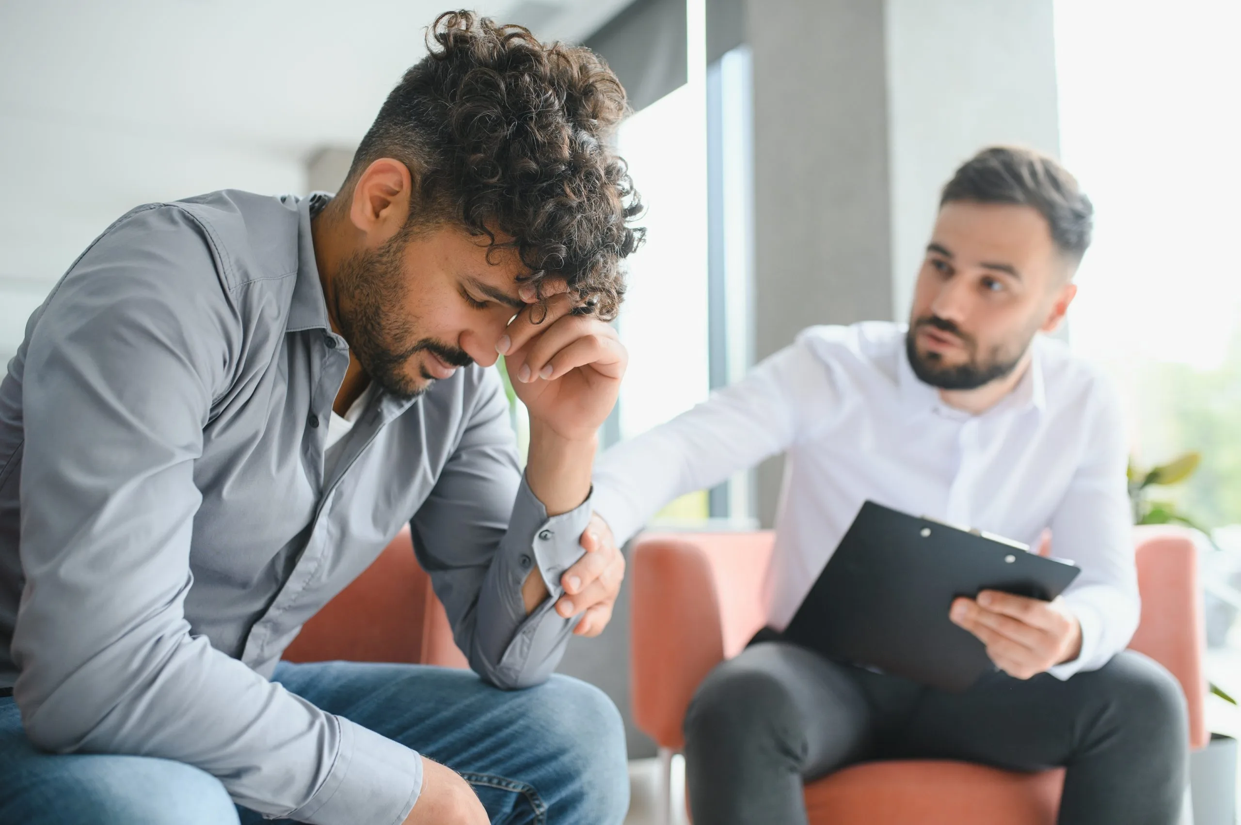 Mental health professional providing support to a patient during a therapy session