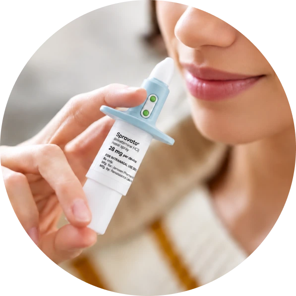 Person holding Sparvato nasal spray applicator near their nose