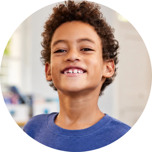 Young boy smiling at camera in clinical setting