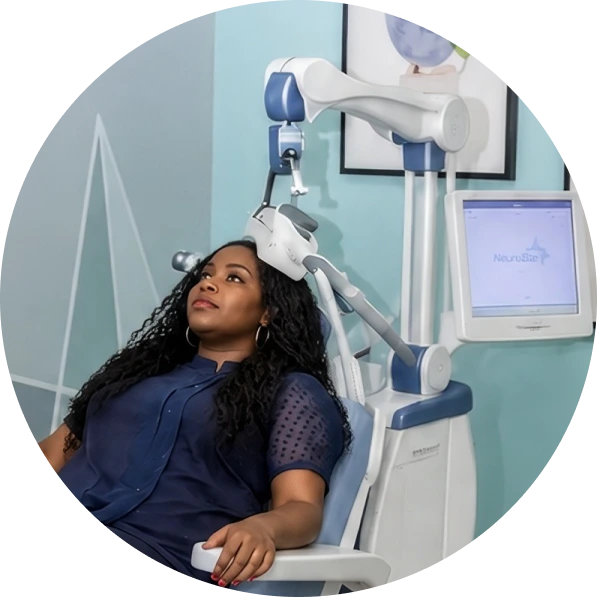 Patient receiving transcranial magnetic stimulation (TMS) treatment with NeuroStar device at Reliant Family Psychiatry