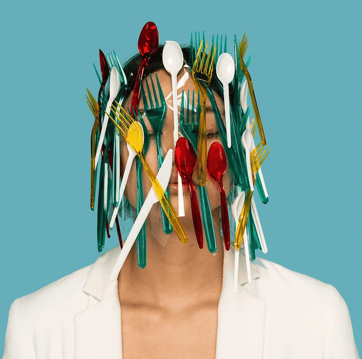 Person's head replaced with colorful utensils symbolizing creativity and mental health expression