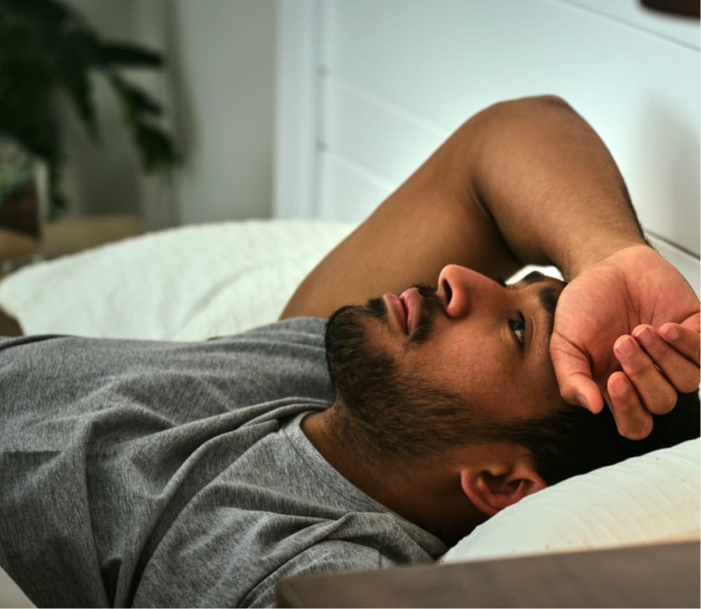 Man lying in bed awake at night, unable to sleep