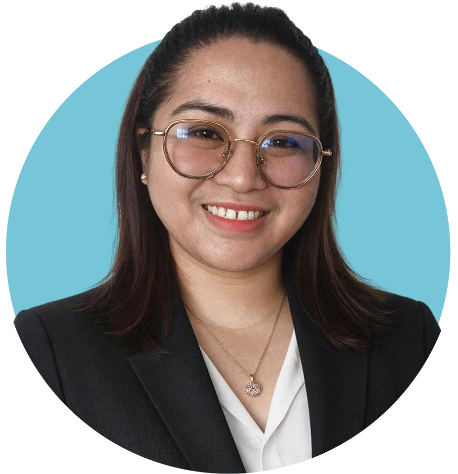 Healthcare provider wearing glasses and business attire, smiling against teal background