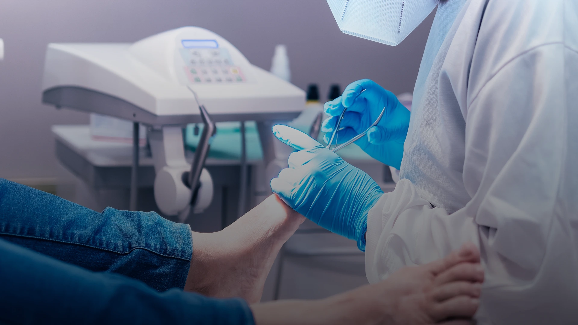 Podiatrist in blue gloves examining patient's foot with medical instrument
