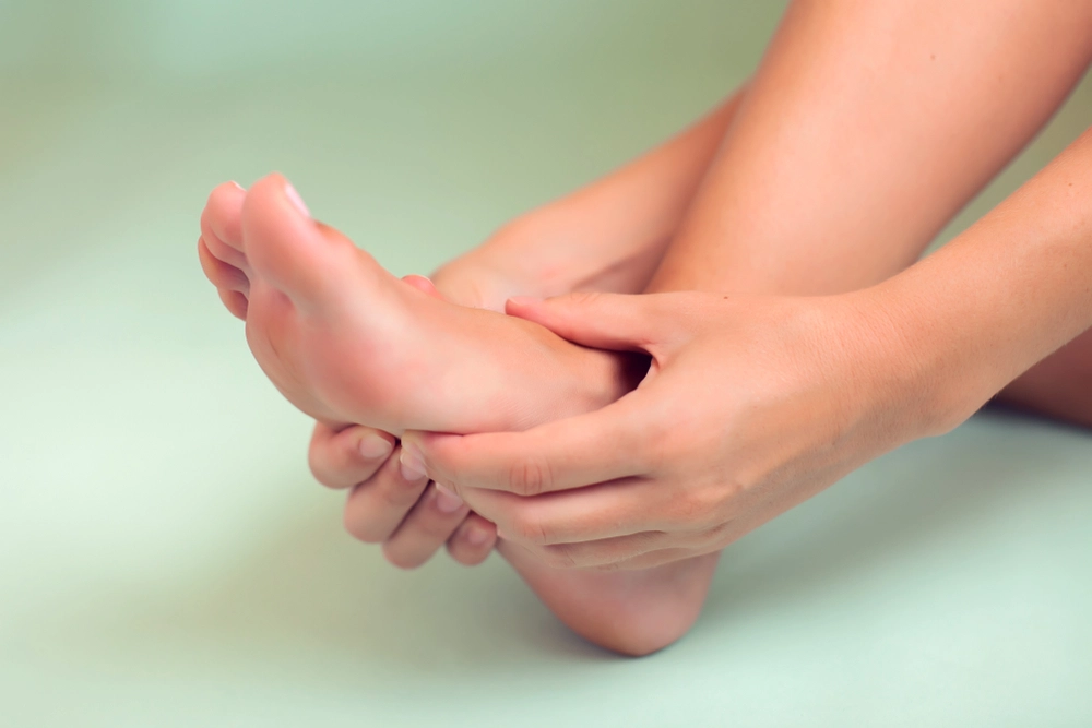 Hands massaging and examining a patient's heel and sole