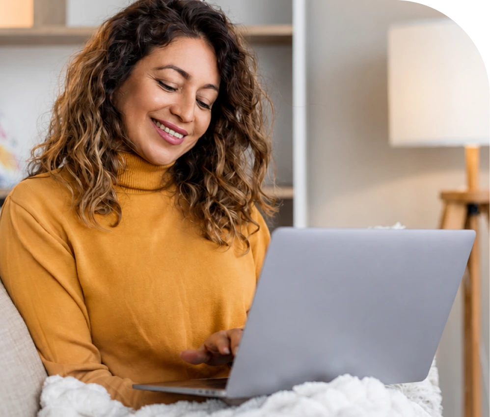 Smiling woman reviewing self-pay options on her laptop
