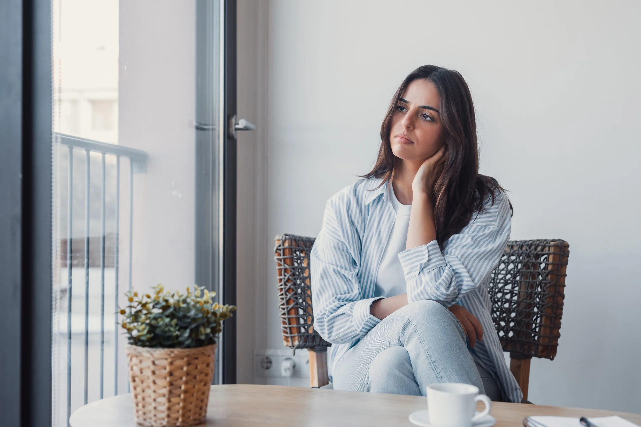 Woman with anxiety nervously squeezing her hands while sitting