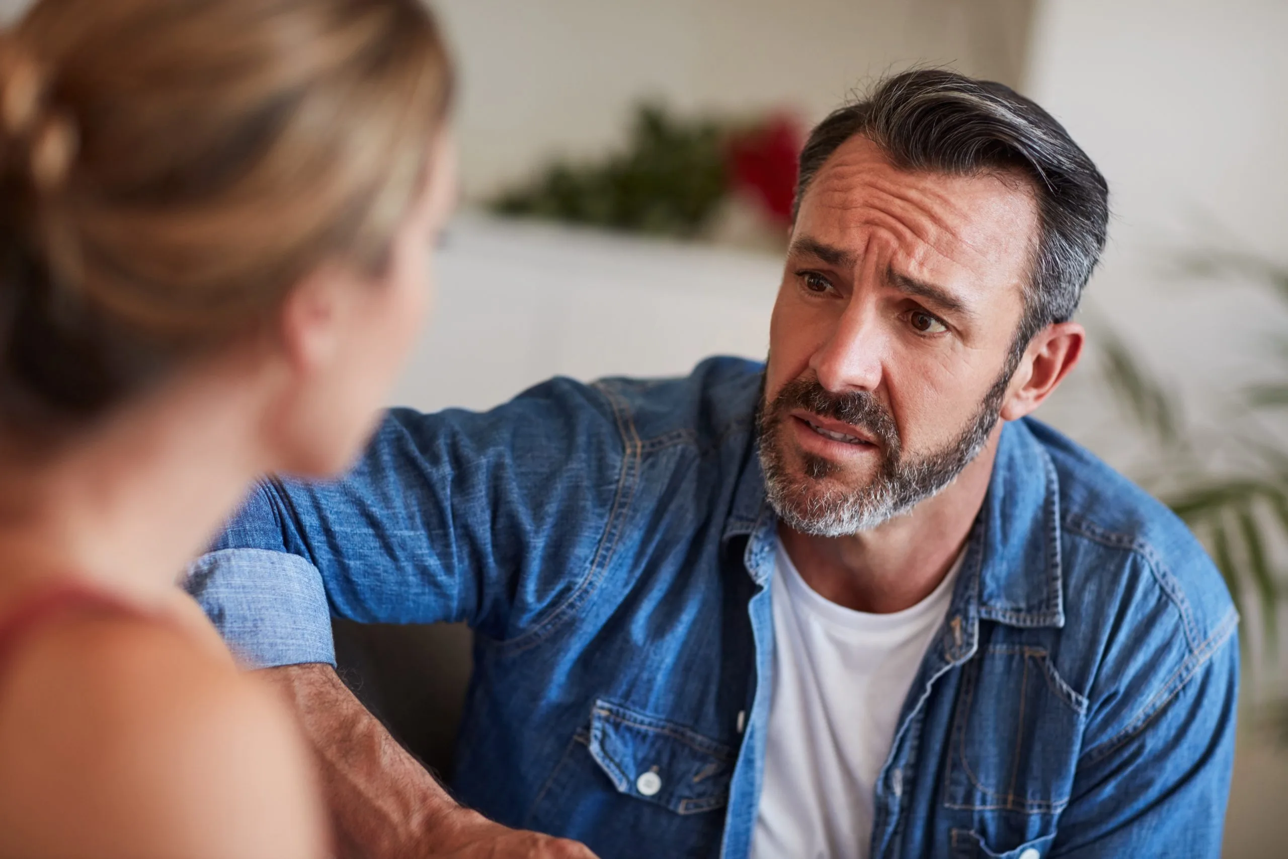 Provider supporting a couple on a couch during an emotional-health consultation