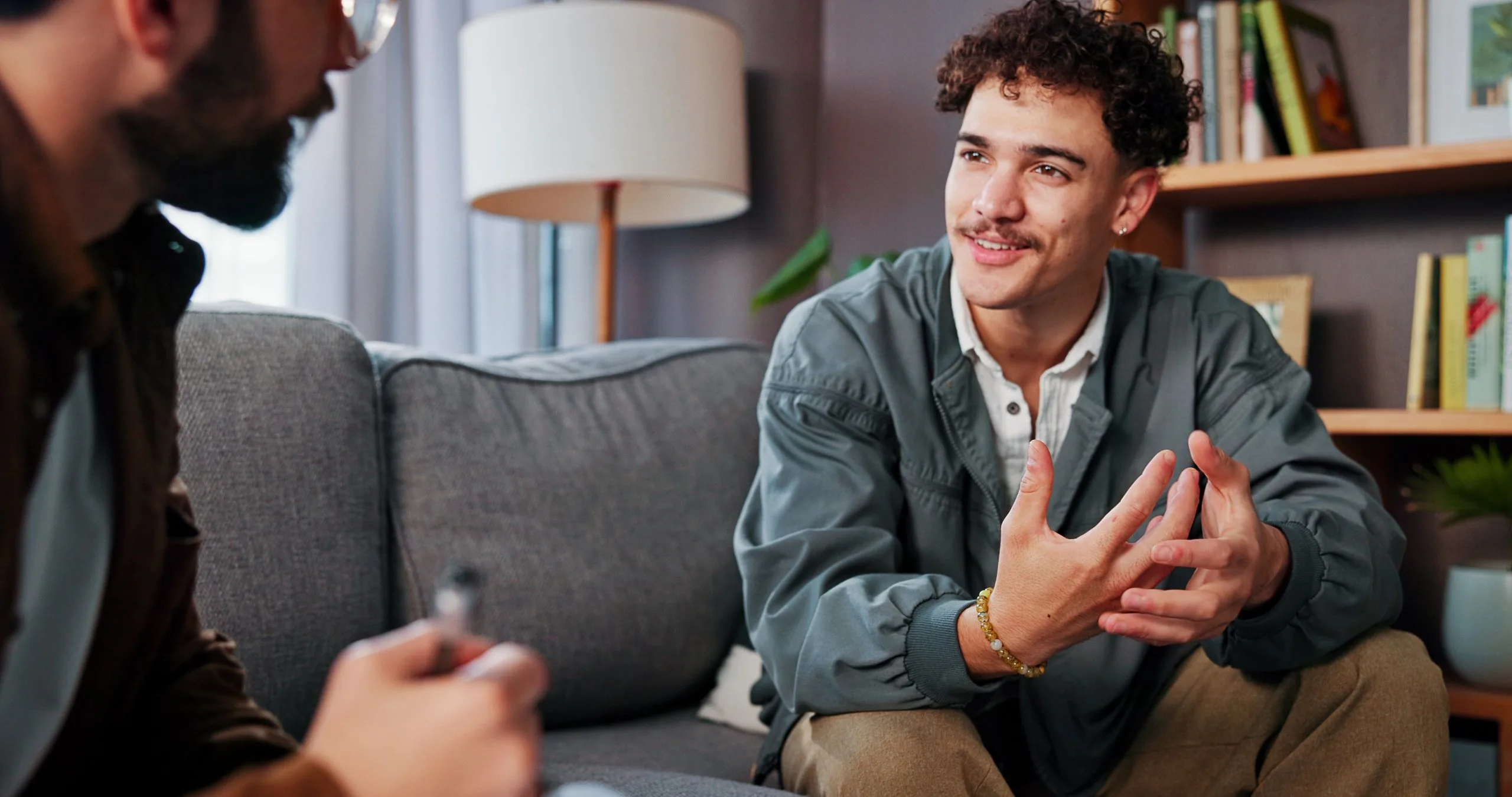 Therapist talking with a smiling man during a mental health appointment in Alhambra, CA