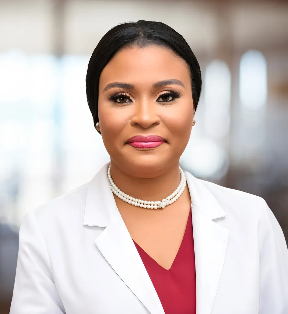 Professional woman in white blazer and pearl necklace