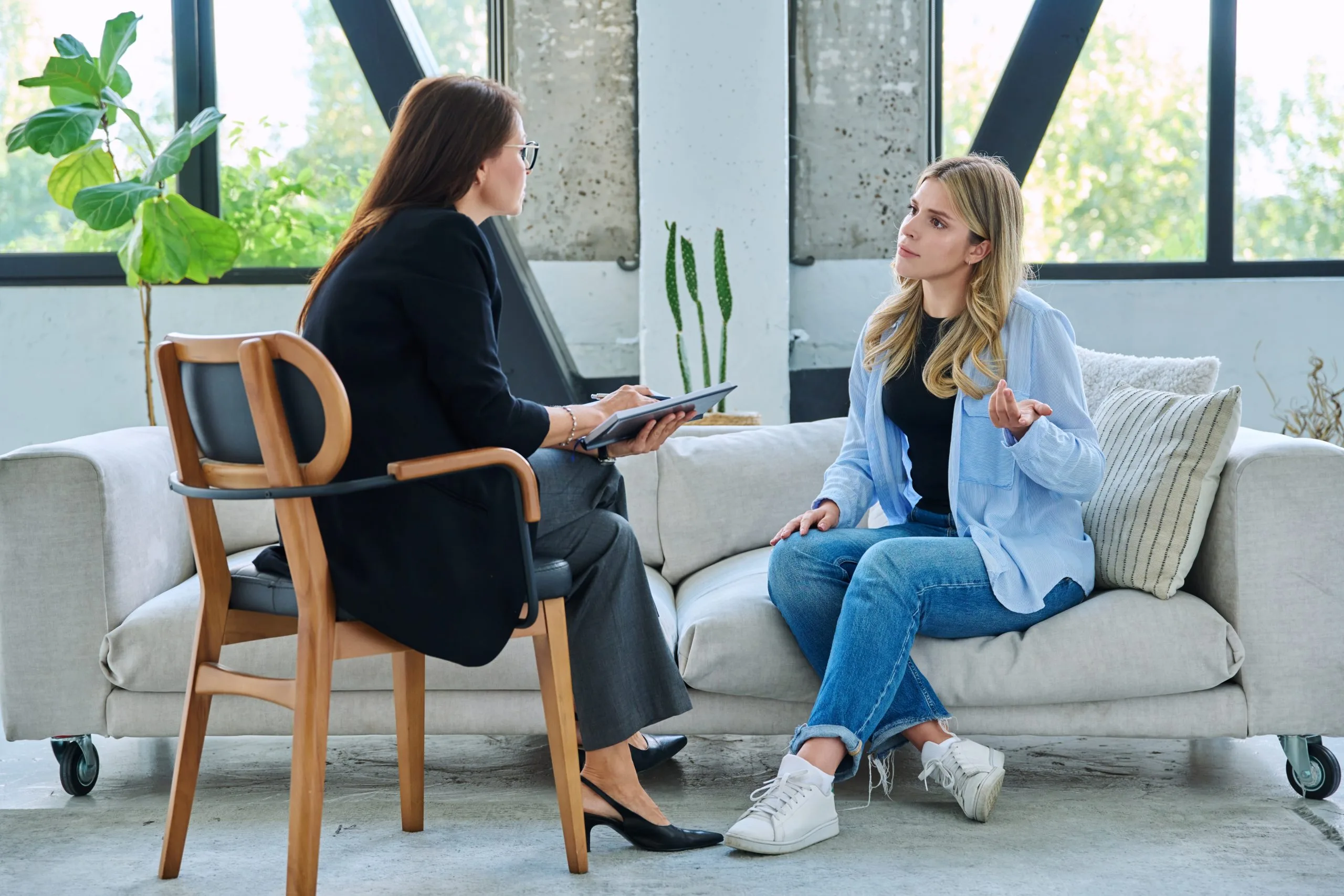 Two women discussing treatment options in a modern clinical consultation room