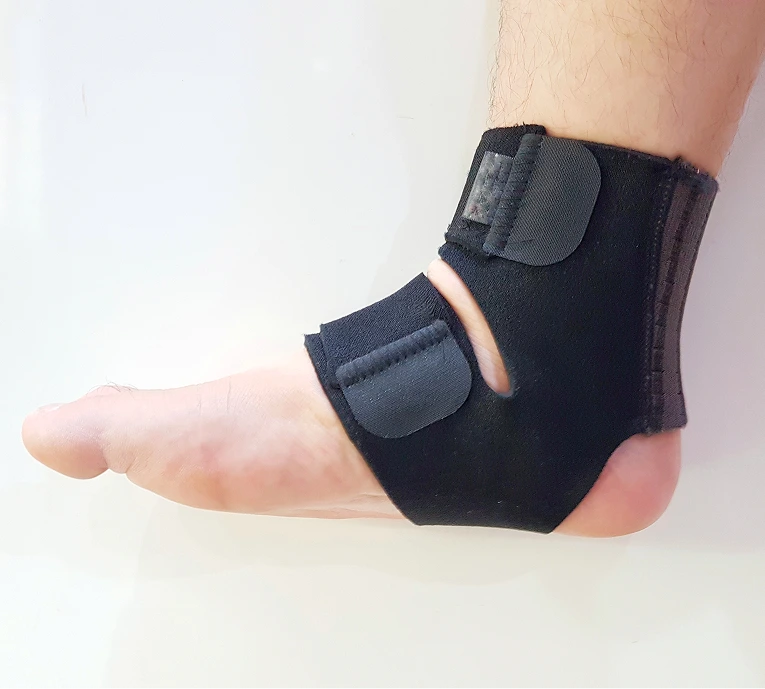 Black ankle brace with gray support panels worn on right foot