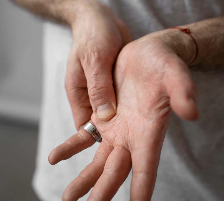 Healthcare provider's hands demonstrating finger examination or injection point