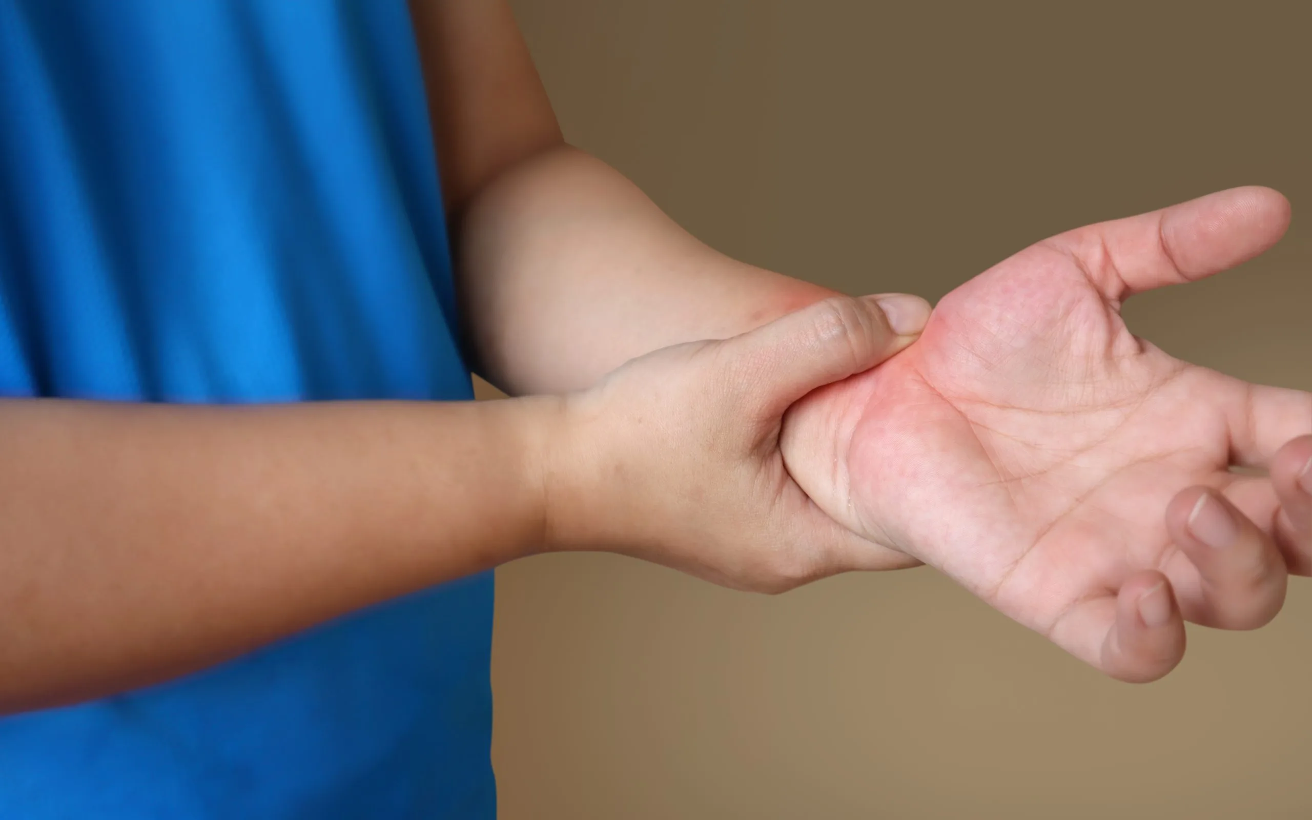Practitioner examining a child's arm and hand during assessment