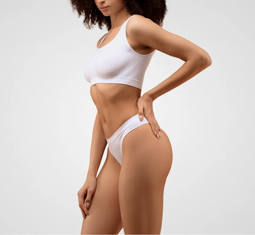 Woman in white sports bra and briefs demonstrating body contour and posture