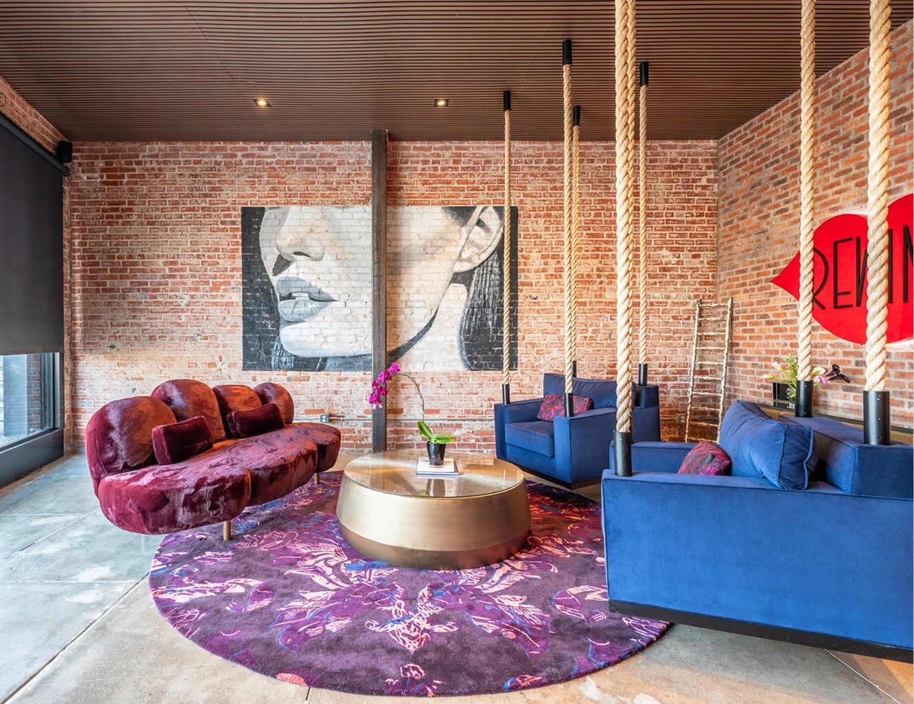 The Rewind Aesthetics lounge in Culver City, with brick walls and the red Rewind lips sign