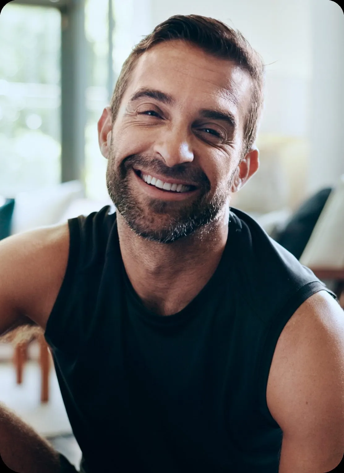 Smiling man at home, a Potential Medicine™ member learning about longevity