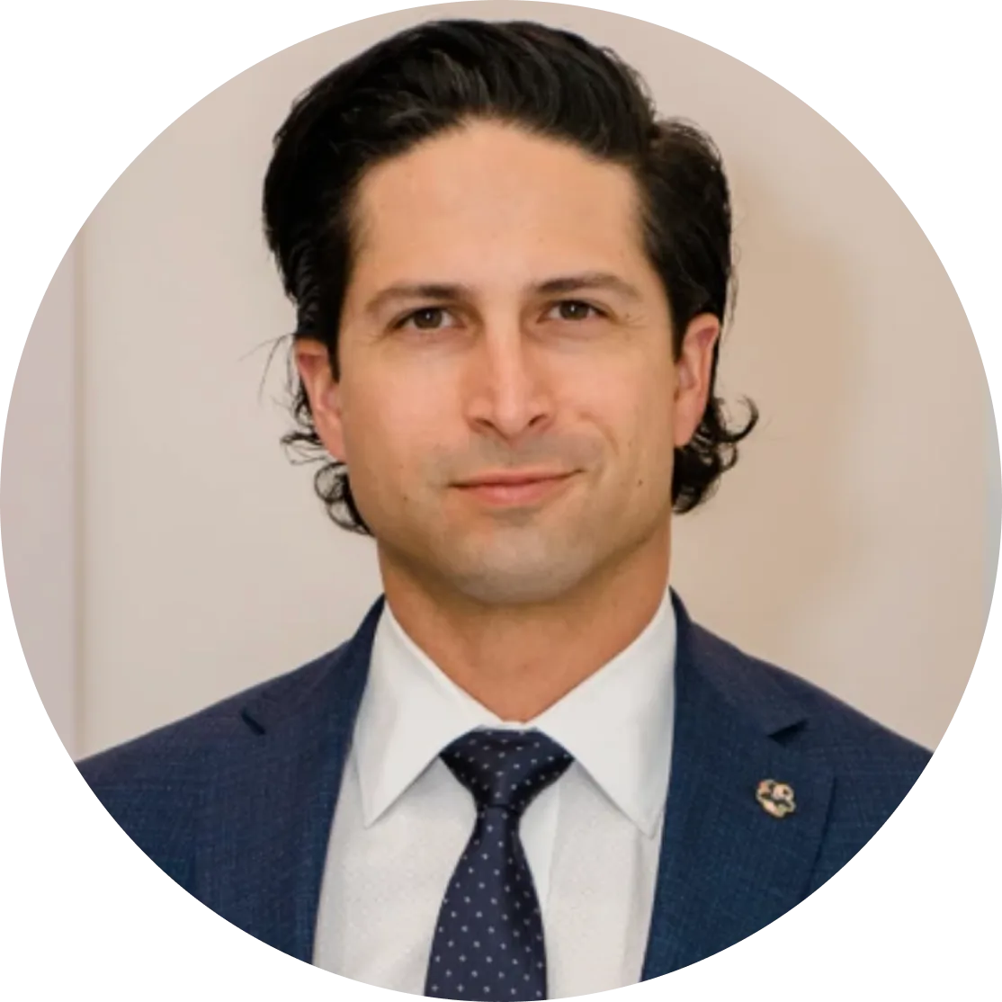 Professional headshot of male surgeon in dark blazer and navy tie