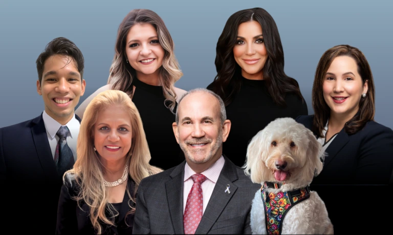 Shorr Solutions team of seven professionals in business attire with a cream-colored dog in colorful collar