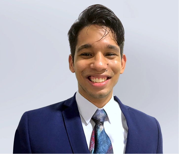 Cristian Devoz smiling in professional headshot wearing navy blazer and patterned tie