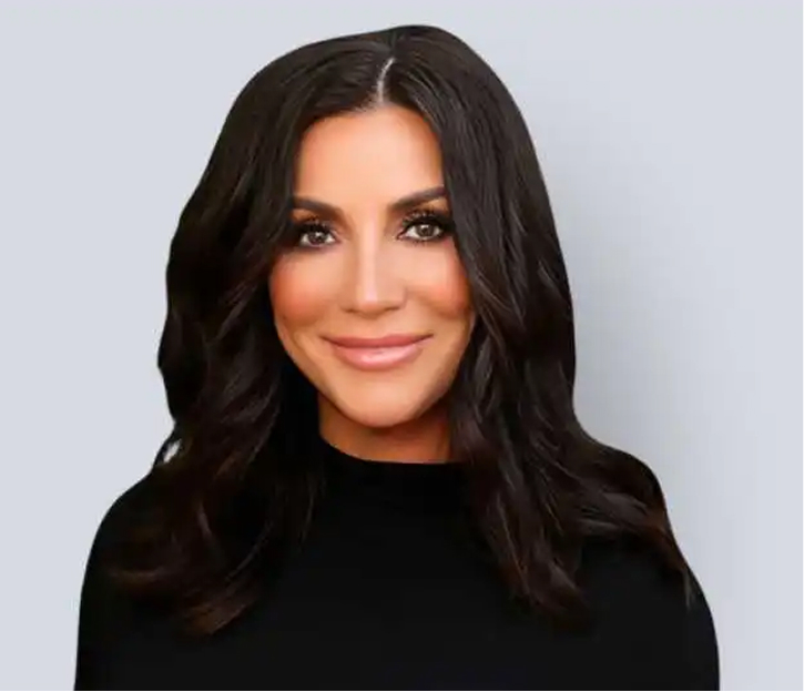 Nanette Maddox, professional headshot with long dark hair wearing black top