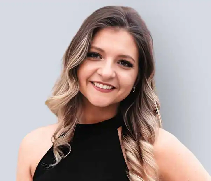 Paige Hamilton, professional headshot with long highlighted hair wearing black top