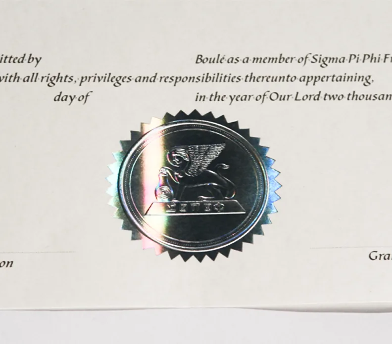 Sigma Pi Phi Fraternity membership certificate with holographic seal featuring eagle emblem on document text