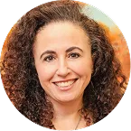 AnnMarie Staats, woman with long dark curly hair smiling at the camera