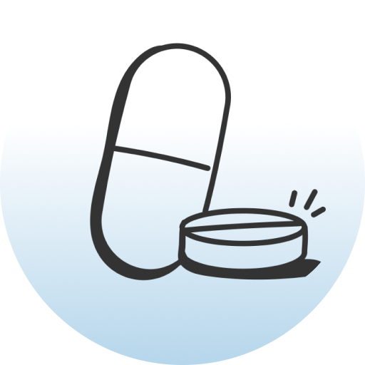 Capsule pill next to a round tablet