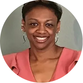 Lasonda, woman wearing coral pink top smiling at camera with neutral background
