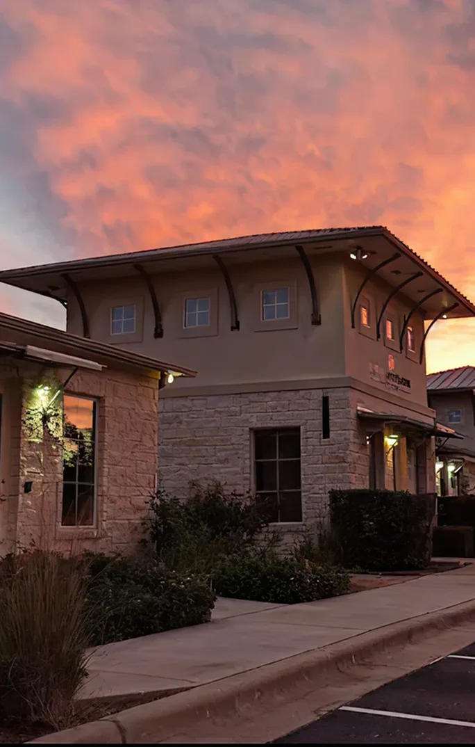 Modern psychiatric office building with stone facade at sunset