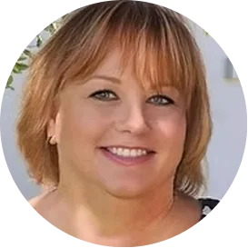 Sherrie Spellman, woman with shoulder-length auburn hair smiling at camera