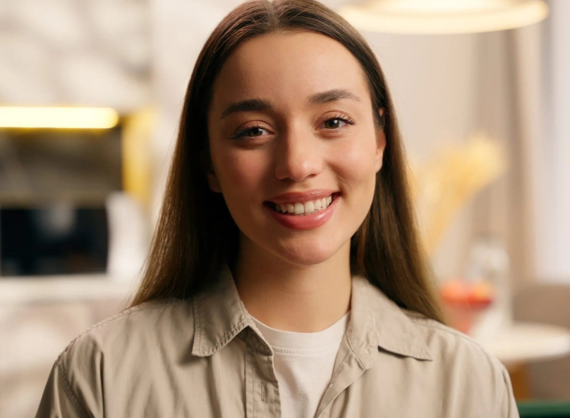 Woman smiling in a bright, modern clinical setting