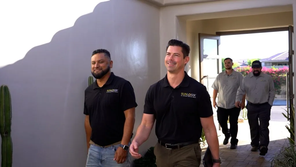 Sunlogix team members walking through an entryway toward outdoor patio area