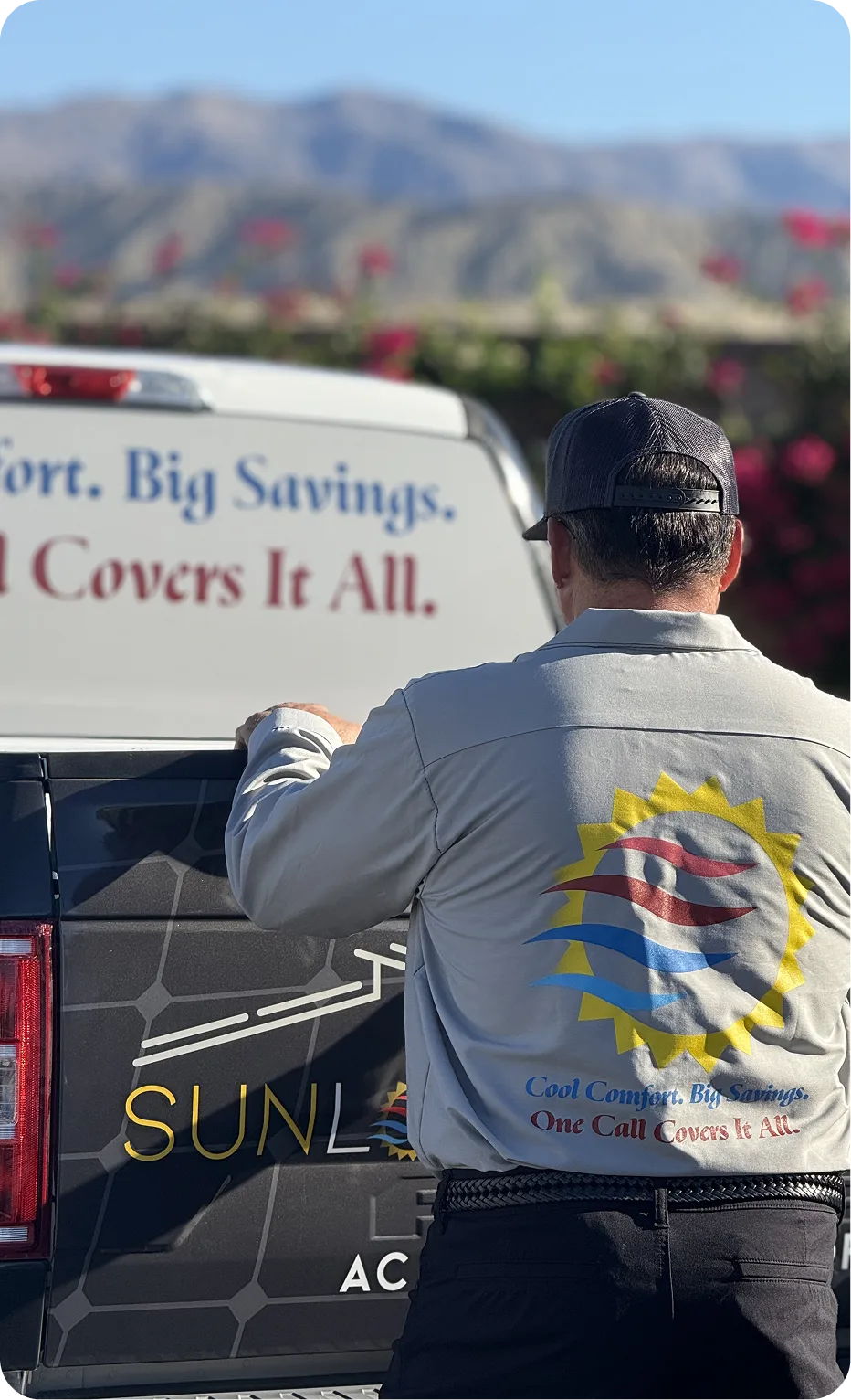 Sunlogix technician loading equipment into service van with desert mountains visible in background