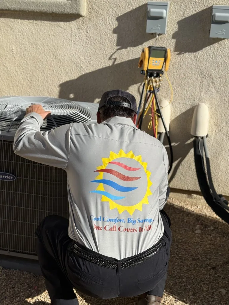 Sunlogix technician inspecting air conditioning compressor with diagnostic equipment and electrical meter visible