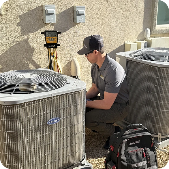 HVAC technician adjusting Carrier air conditioning unit with diagnostic equipment and toolbag