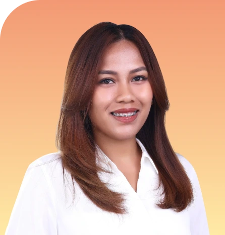 Professional headshot of a woman with long brown hair wearing a white collared shirt against an orange-to-yellow gradient background