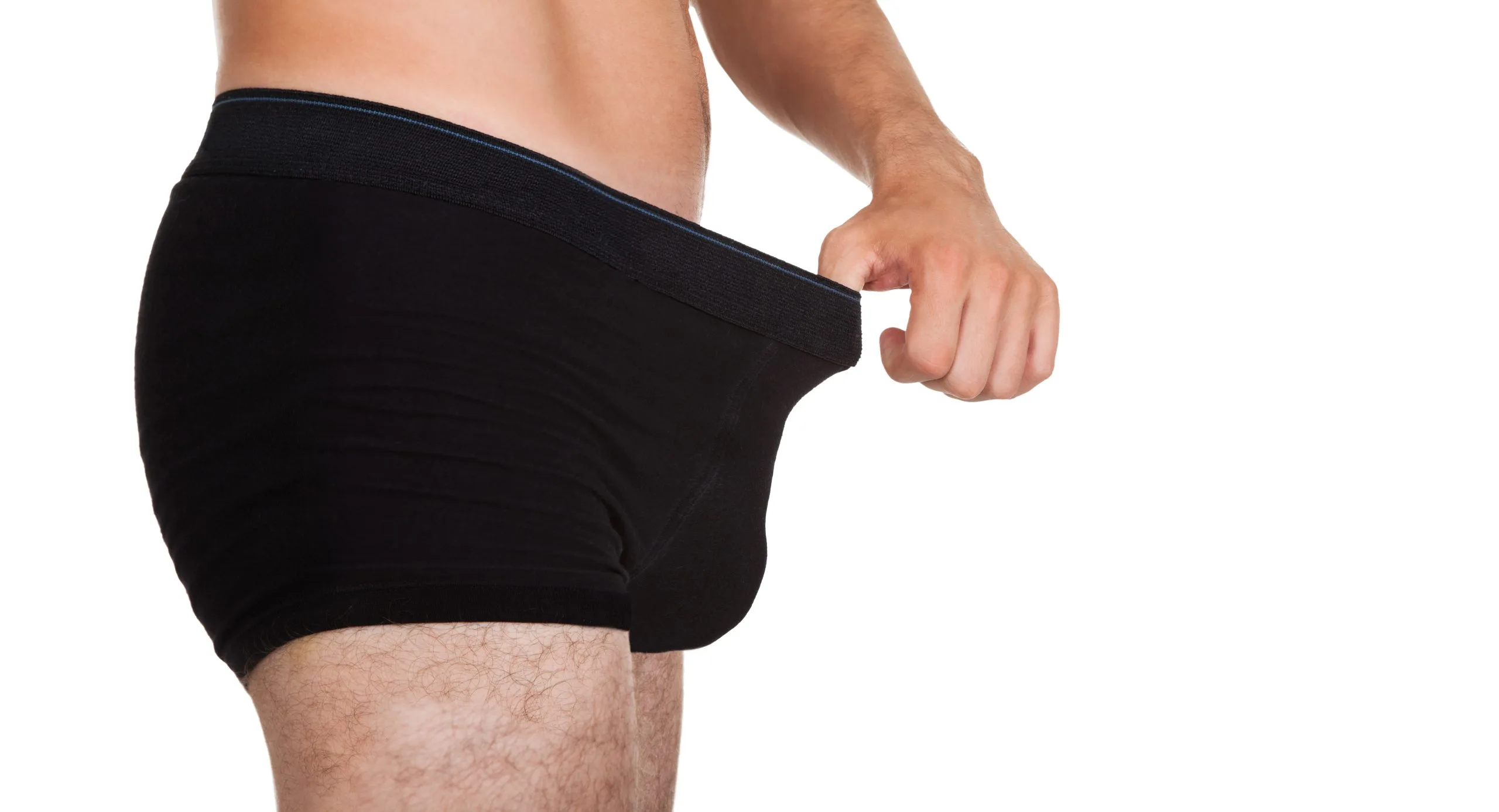 Man in black briefs examining fit at waistband