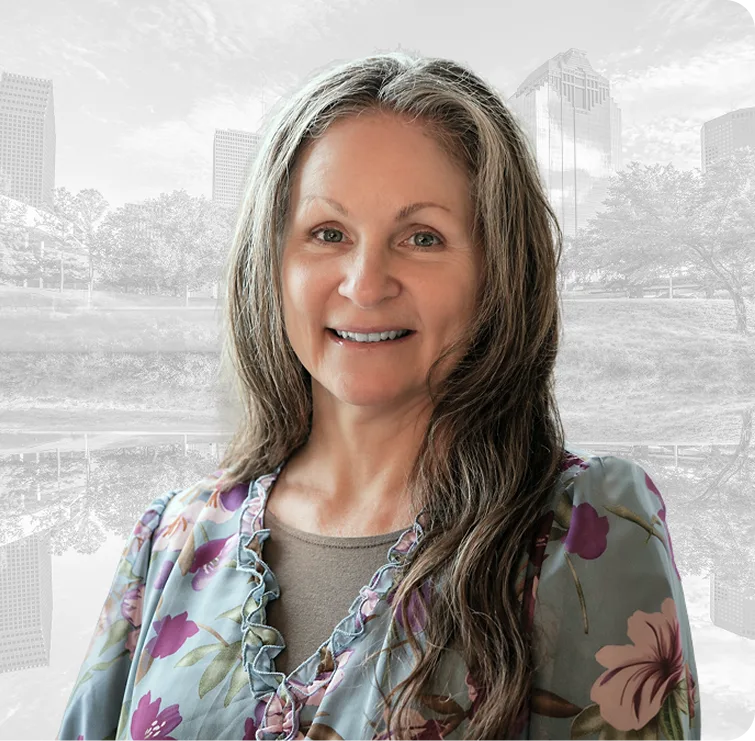 Clayleene, team member at Texas Sinus and Snoring, smiling at camera with cityscape background