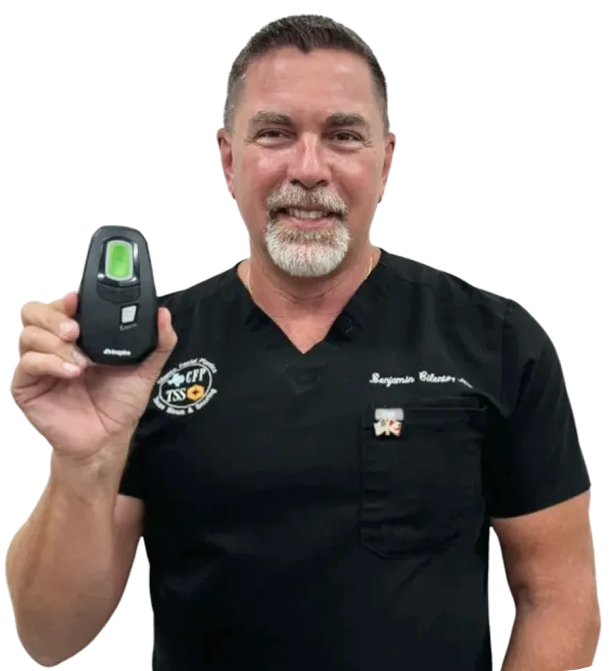 Doctor holding a handheld diagnostic device with green display screen