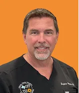 Male physician smiling in black scrubs with Texas Sinus and Snoring logo